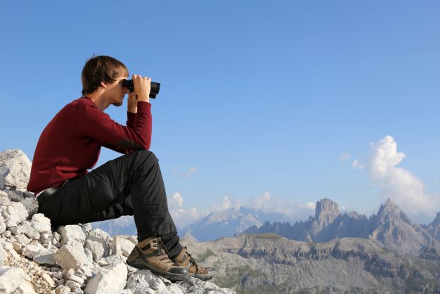 Man looking through binoculars