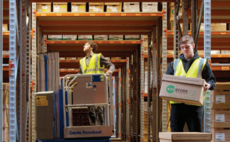 Boxes in warehouse being moved around by forklift truck