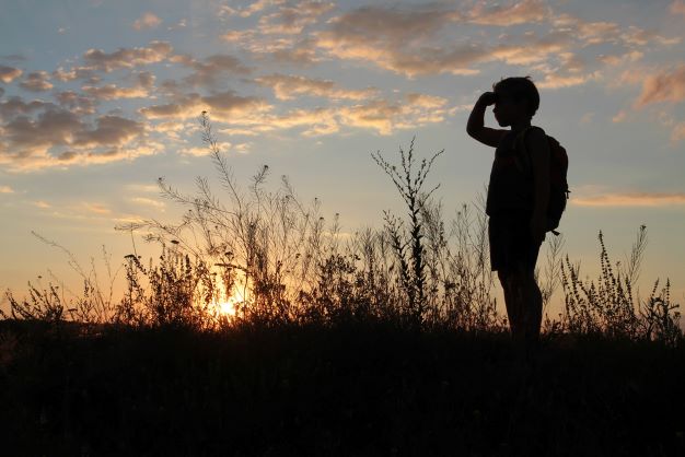 Boy looking at the sunset