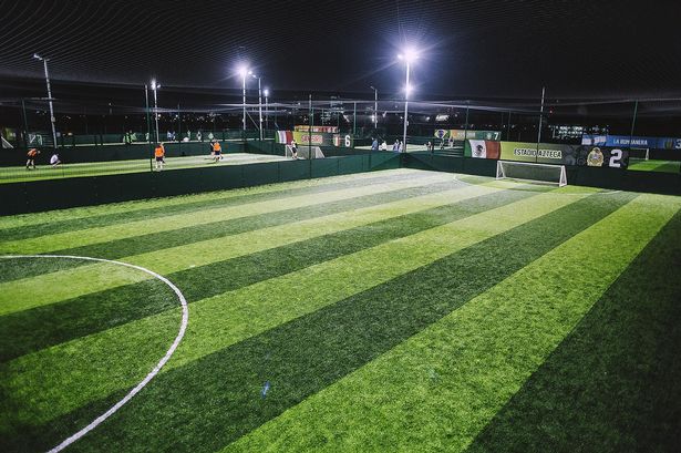 Football field managed by Goals Soccer Centre in floodlights 