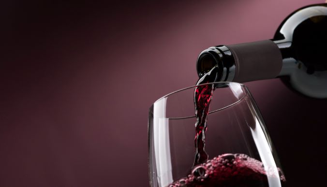 Pouring red wine in glass