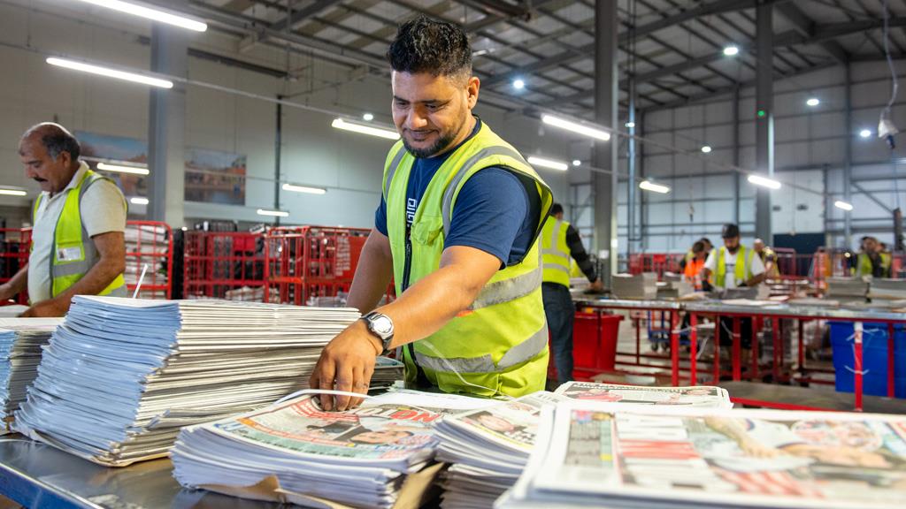 Someone sorting newspapers