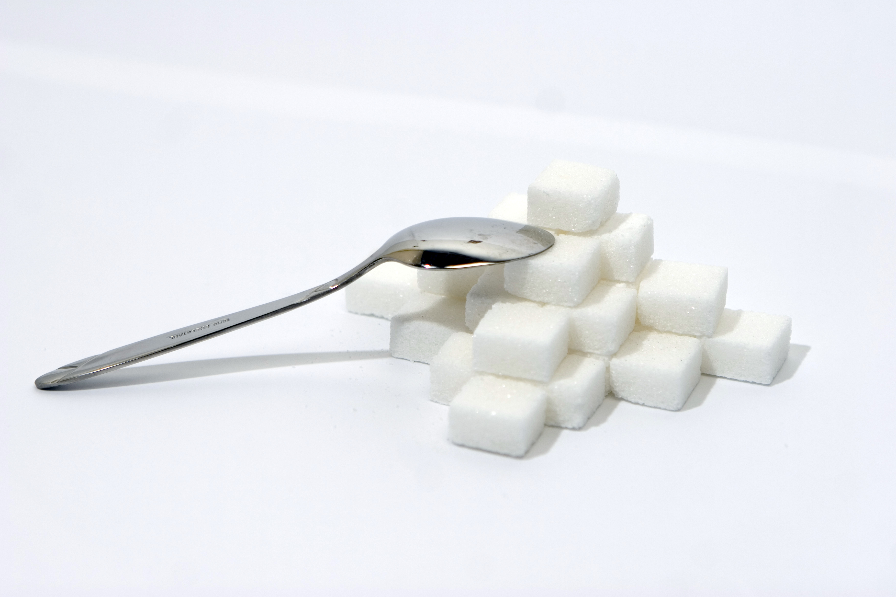 Pile of sugar cubes with spoon resting on them