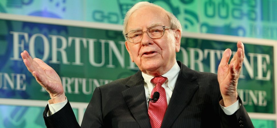 Berkshire Hathaway's Warren Buffett standing in front of green Fortune sign