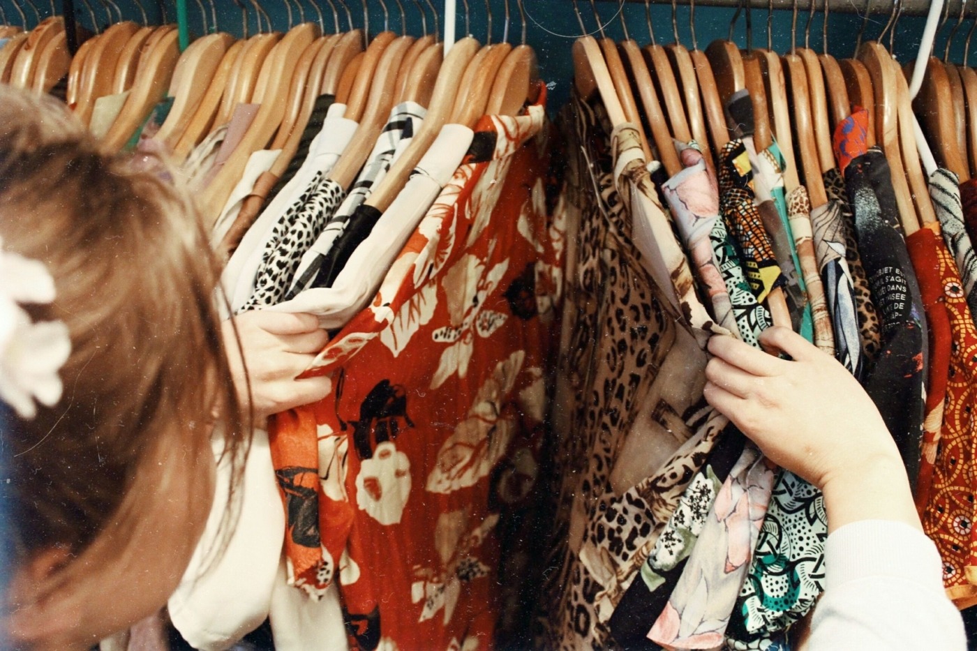 Lady browsing through shirts on a rack