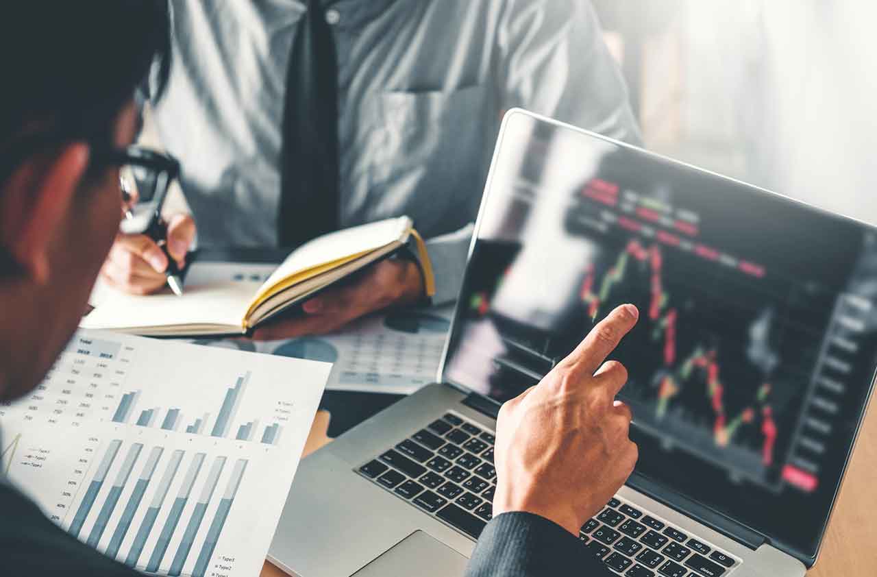 Businessman pointing at screen showing inverted yield curve